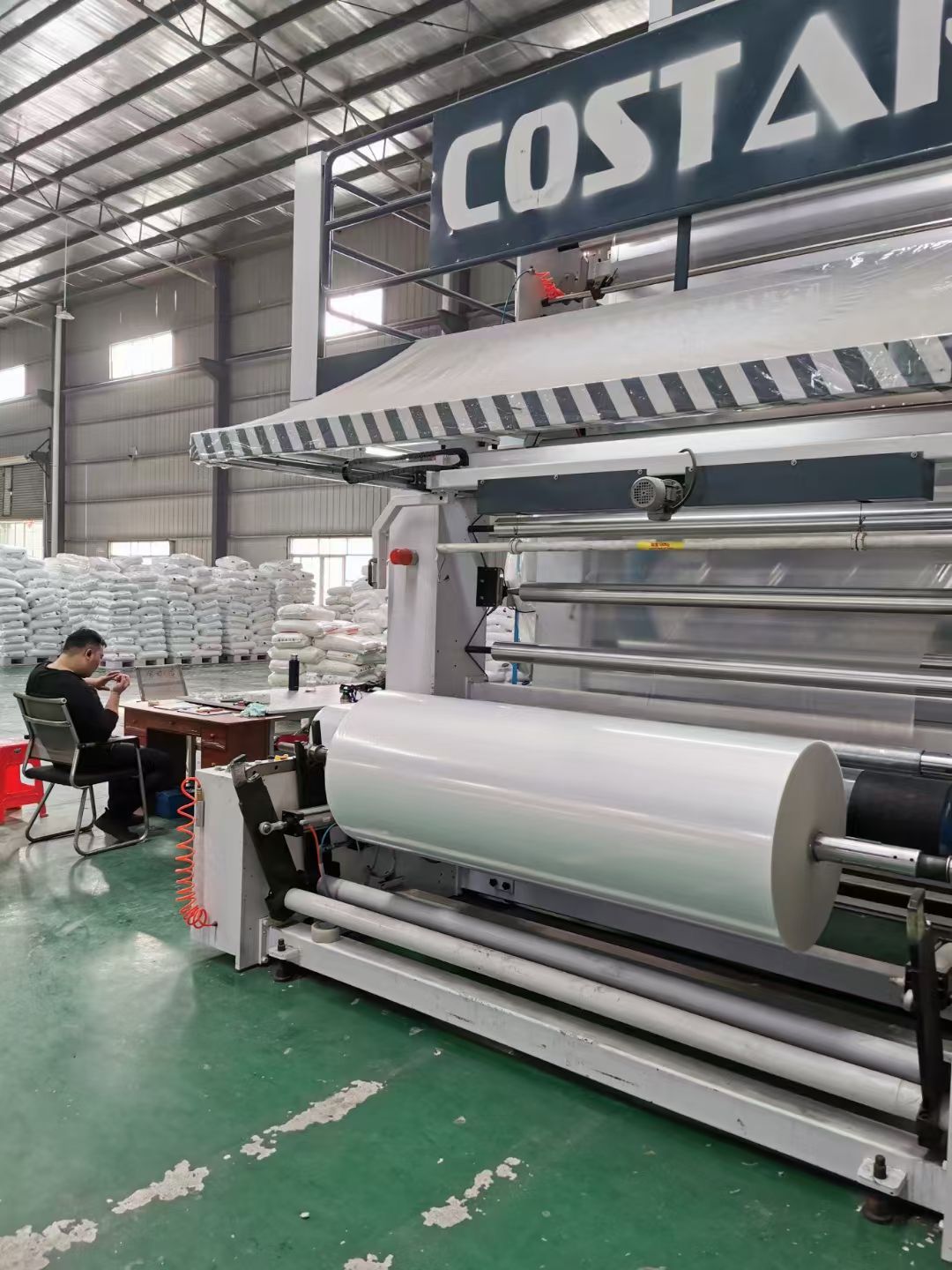Protective film coating and rewinding equipment at a TDH partner factory